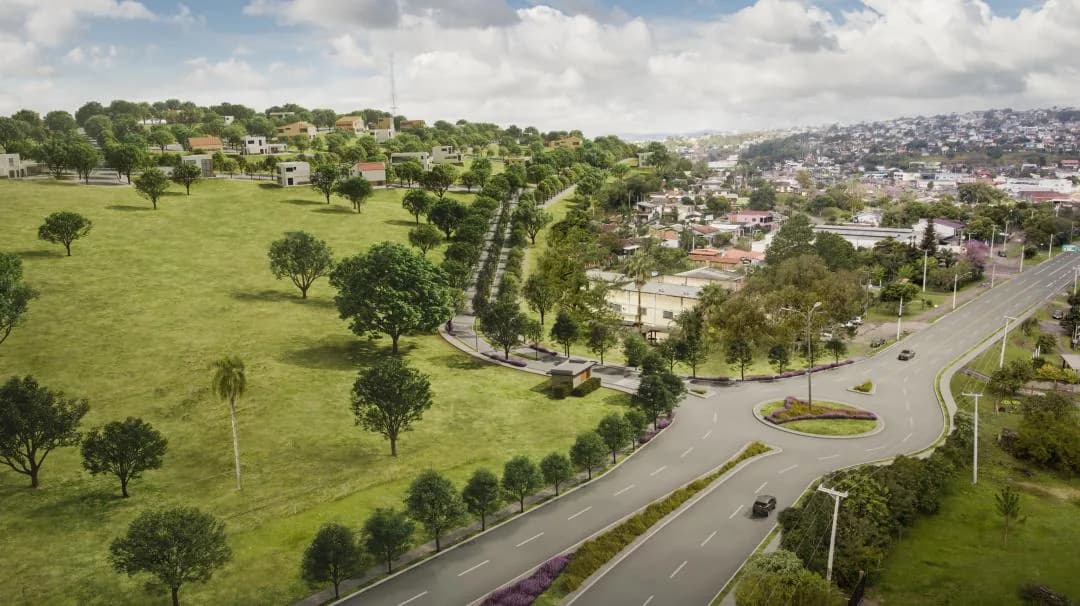 Vista aérea do loteamento, com as quadras abertas e a cidade ao fundo.