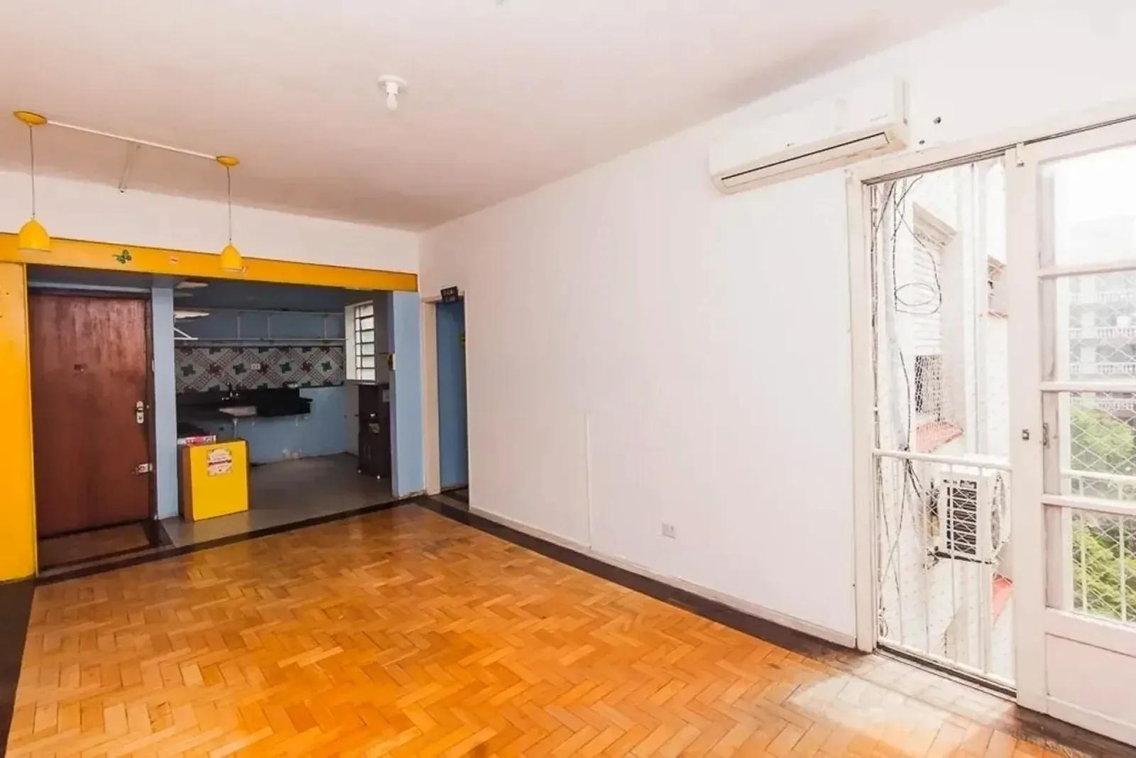Living com piso de parquet integrado à cozinha