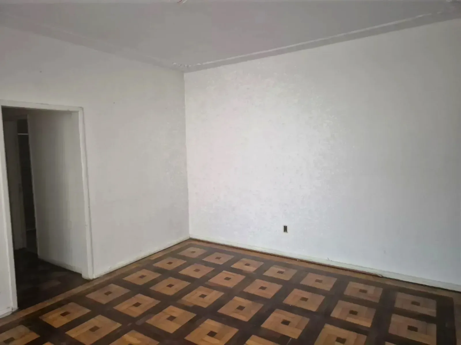 Dormitório com parquet e porta para o corredor