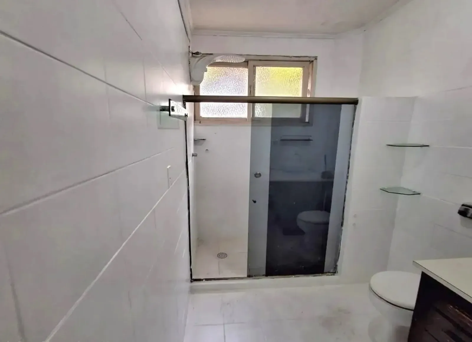 Banheiro com janela e box de vidro