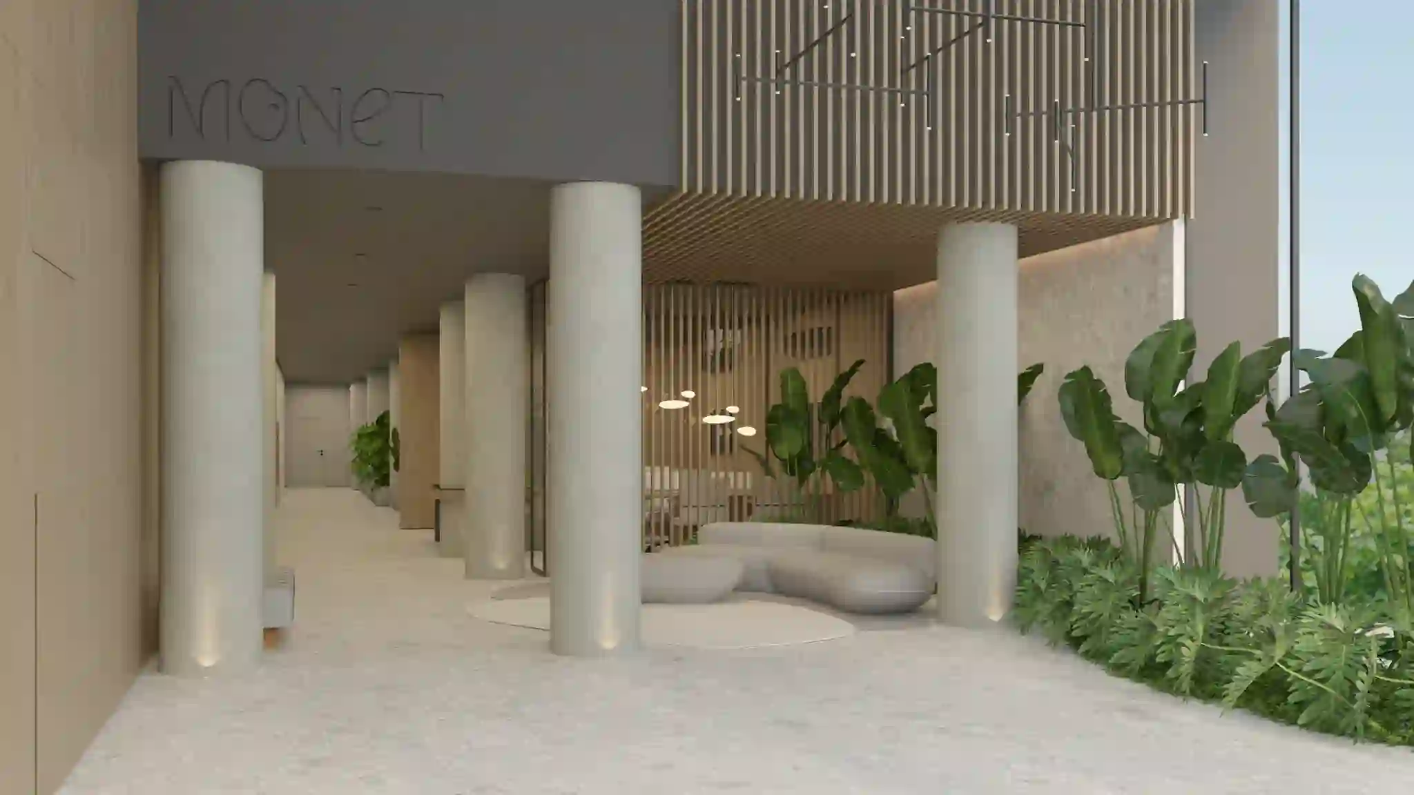 Hall de entrada com pé-direito duplo e o nome Monet em relevo na parede.