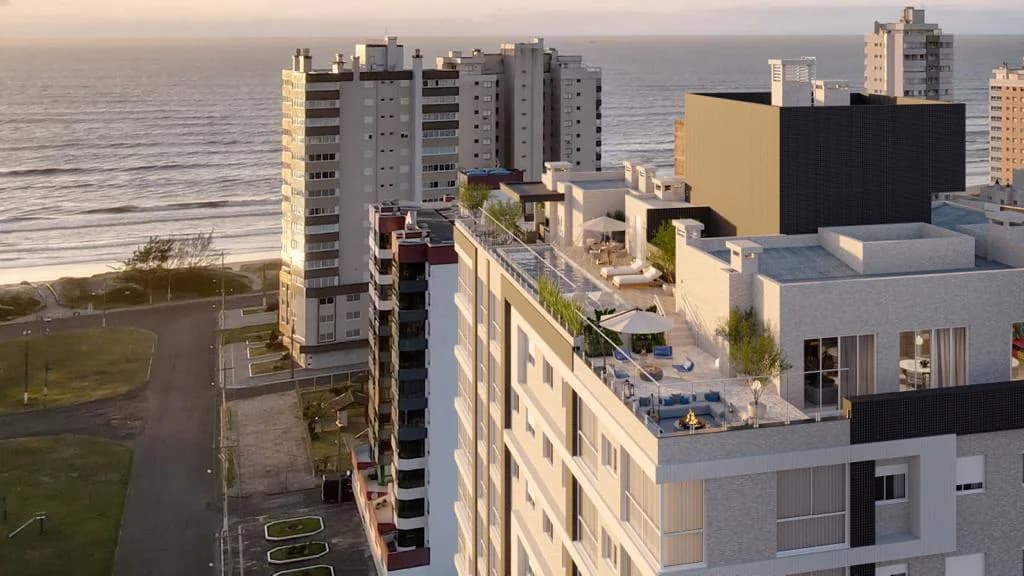 Perspectiva do empreendimento no conjunto do bairro, com a praia ao fundo.